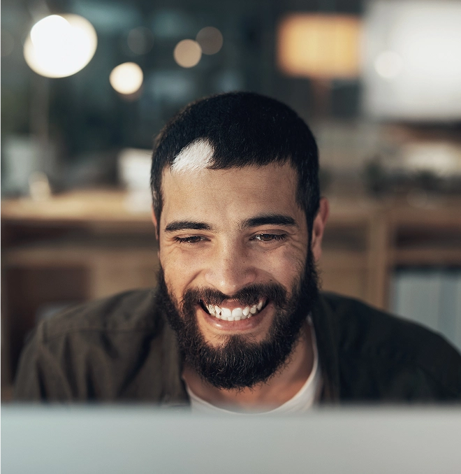 Smiling professional in modern workspace setting, representing the Baselane product walkthrough video experience